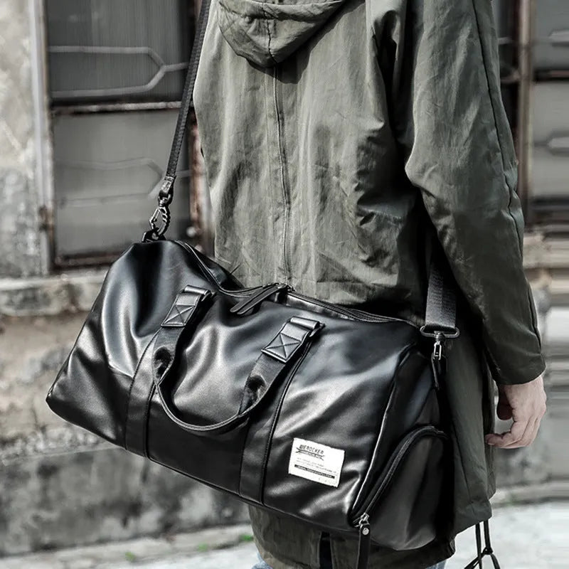 Large black PU leather sports training bag with multiple compartments showing laptop and camera pockets