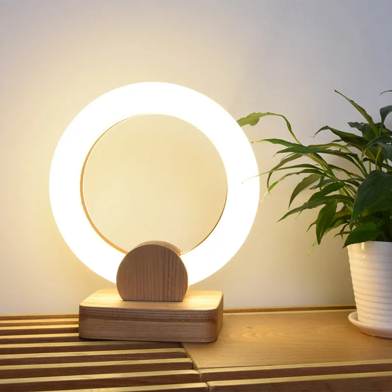 Modern wooden circular chandelier with a white acrylic shade hanging from a ceiling.