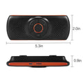Orange Bluetooth car hands-free speaker clipped onto a sun visor with wireless smartphone pairing for 3W audio output