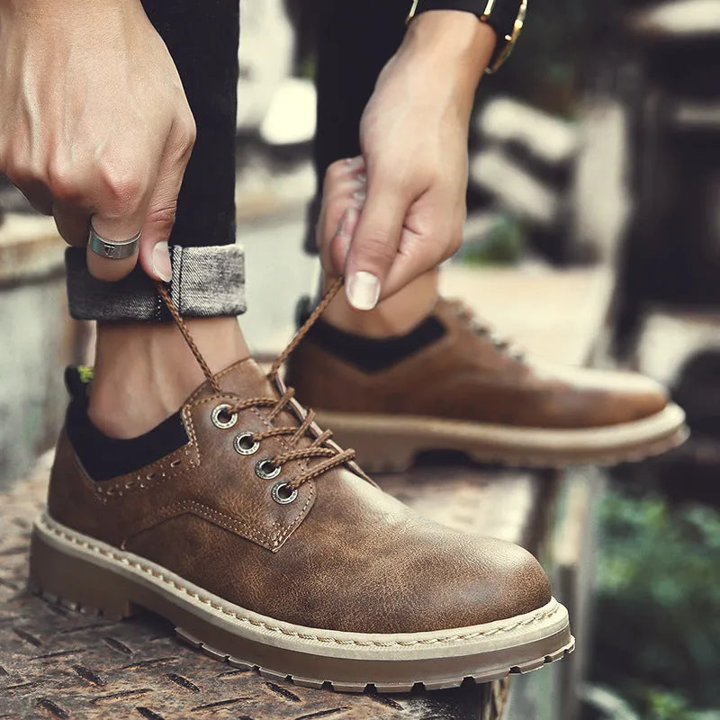 Men's black casual shoes with round toe, flat rubber sole, and front-tie laces.