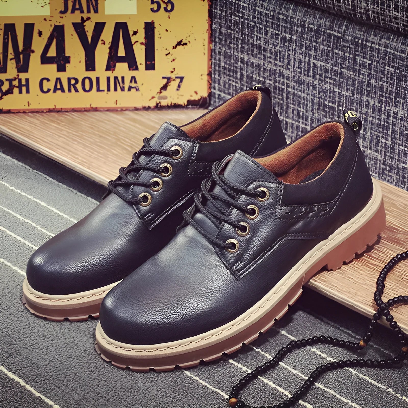 Men's black casual shoes with round toe, flat rubber sole, and front-tie laces.