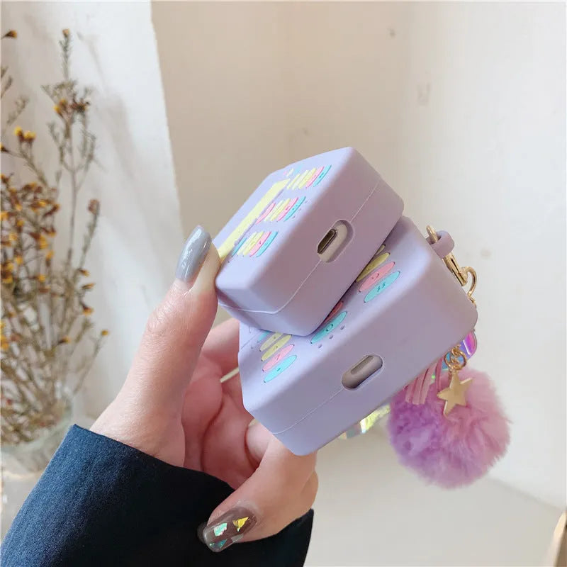 Purple silicone AirPods case with fur ball pendant accessory