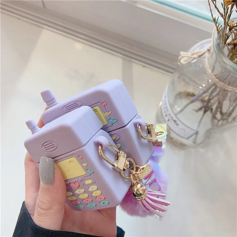 Purple silicone AirPods case with fur ball pendant accessory