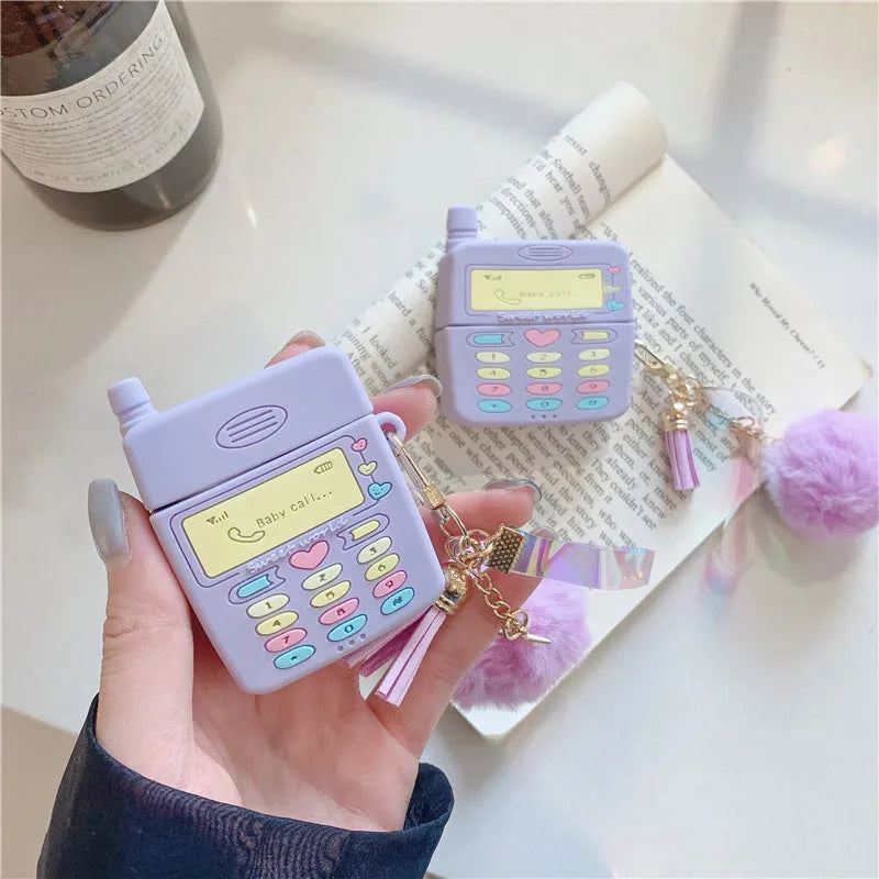 Purple silicone AirPods case with fur ball pendant accessory