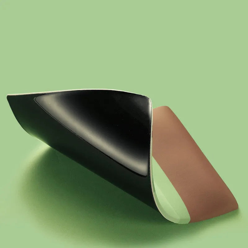 Green kiwi fruit shaped soft gel wrist support mouse pad on a desk.