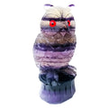 Hand carved purple fluorite owl statue approximately 4 inches tall on a flat surface