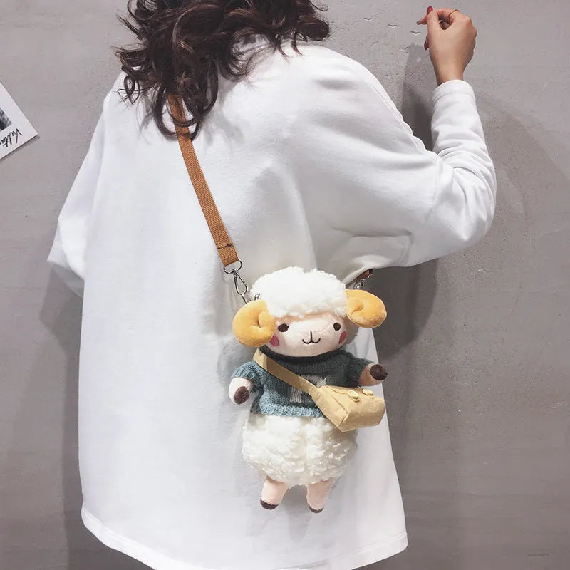 Little Sheep small square crossbody bag in blue plush fabric with a single shoulder strap and zip.