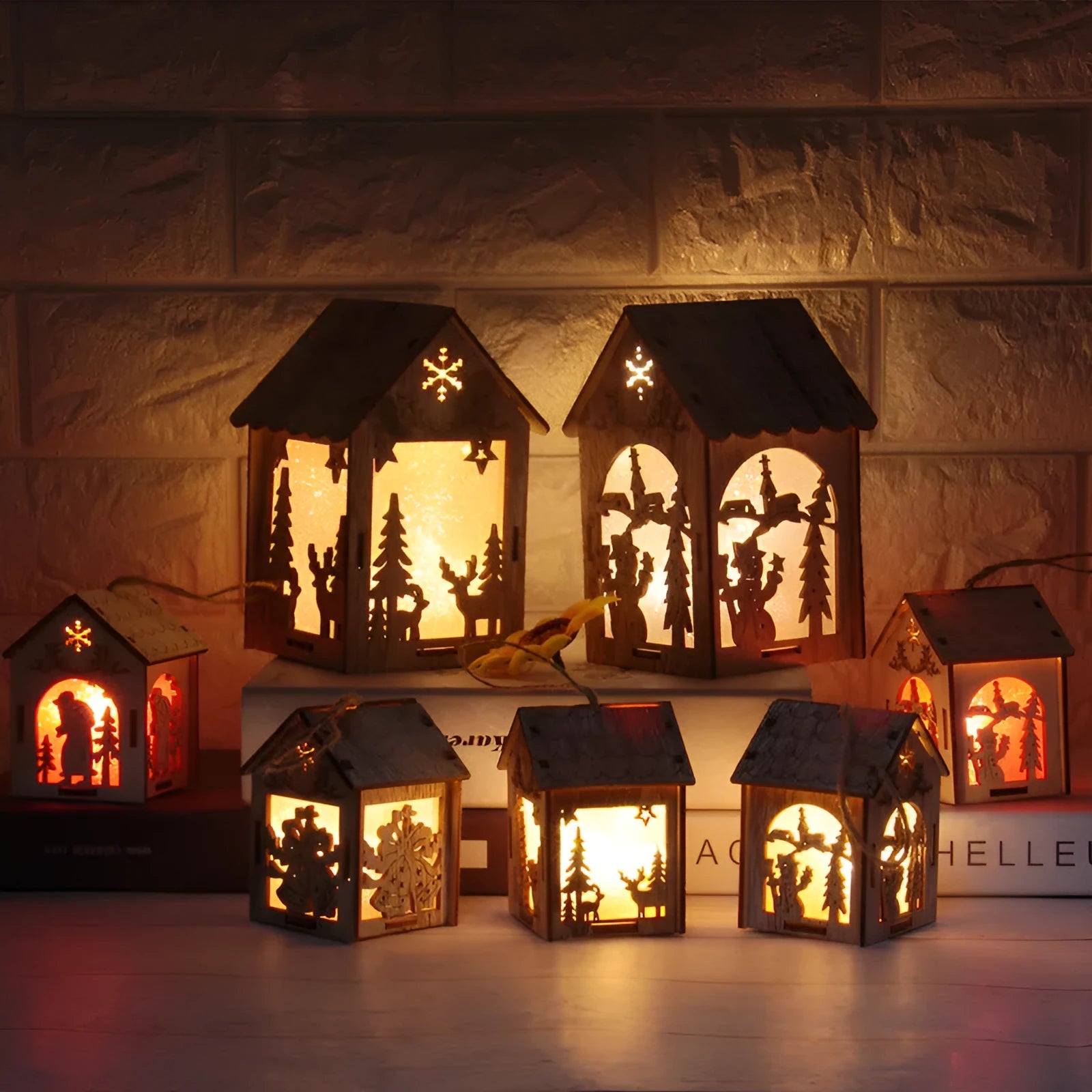 Three wooden Christmas decorations: log bell and two character houses in natural wood colour