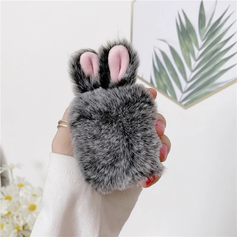 Pink silicone AirPods protective cover with grey plush rabbit ears design