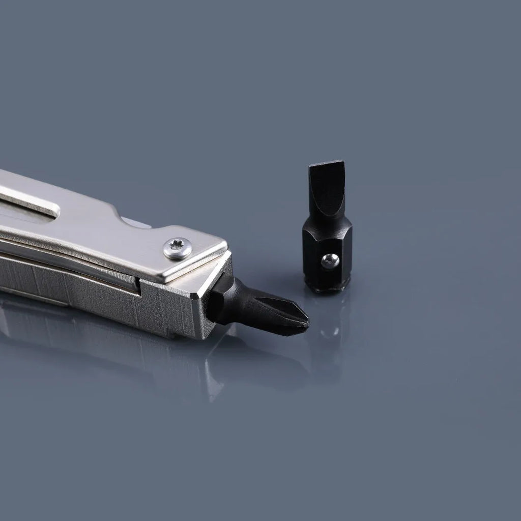 White-handled stainless steel multi-tool showing wrench, knife blade, and needle-nose pliers functions.
