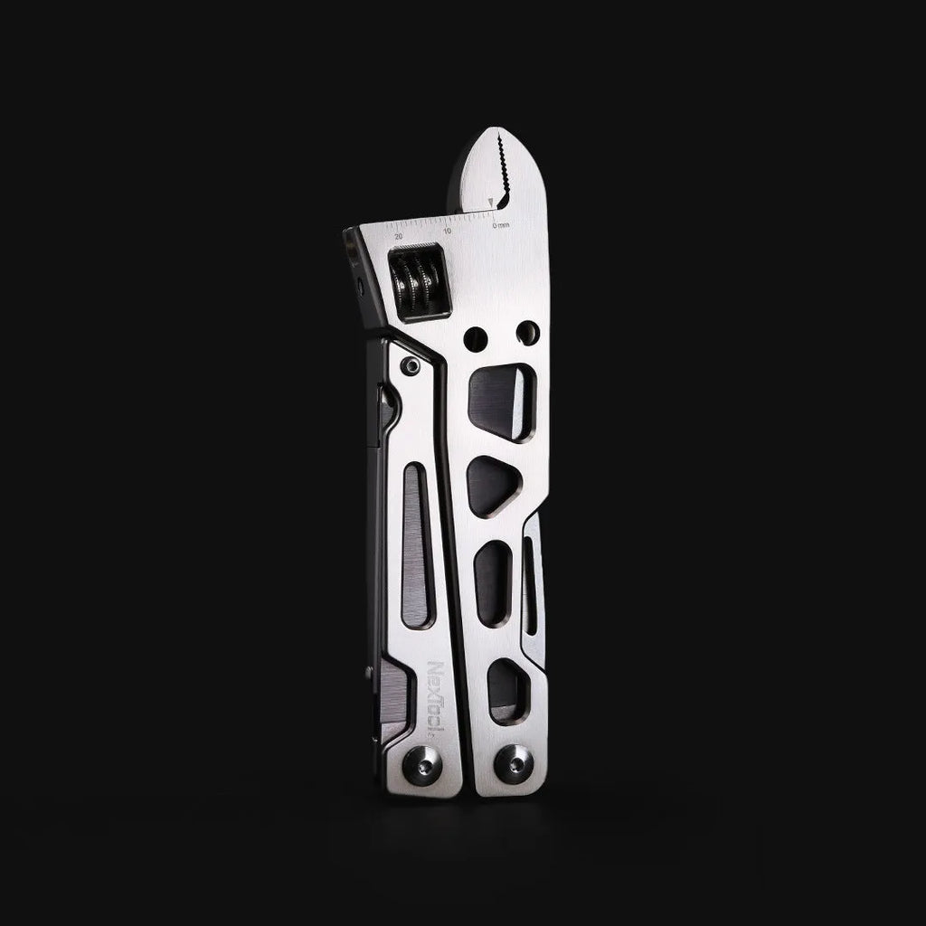 White-handled stainless steel multi-tool showing wrench, knife blade, and needle-nose pliers functions.
