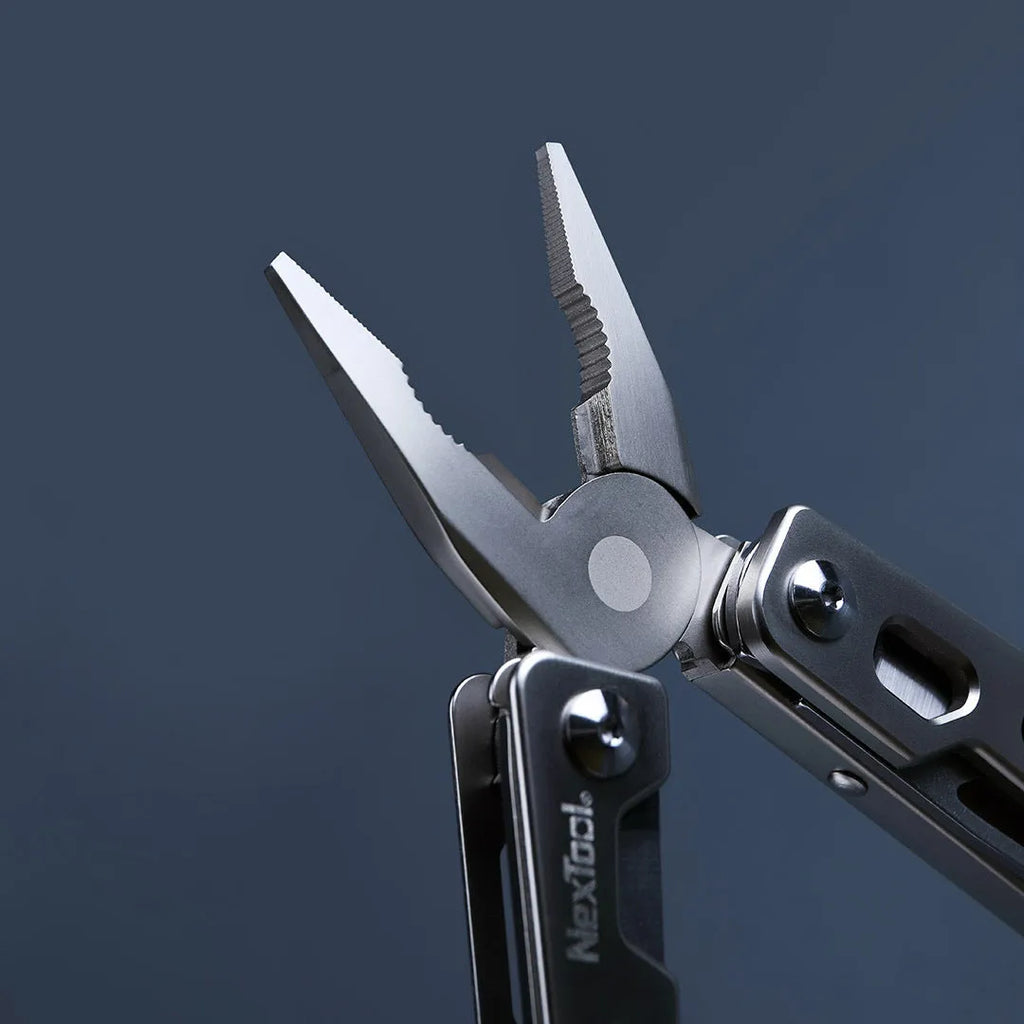White-handled stainless steel multi-tool showing wrench, knife blade, and needle-nose pliers functions.