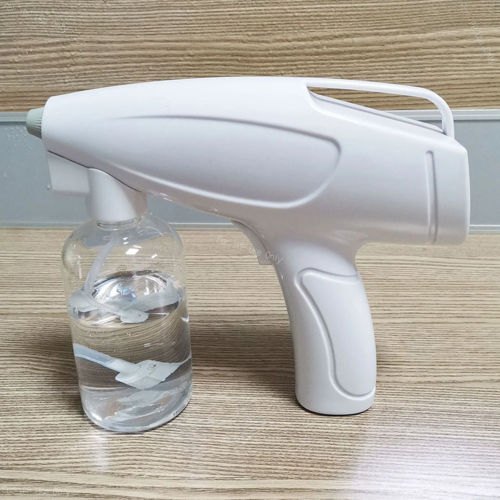 White handheld cordless electric disinfection sprayer with spray bottle.