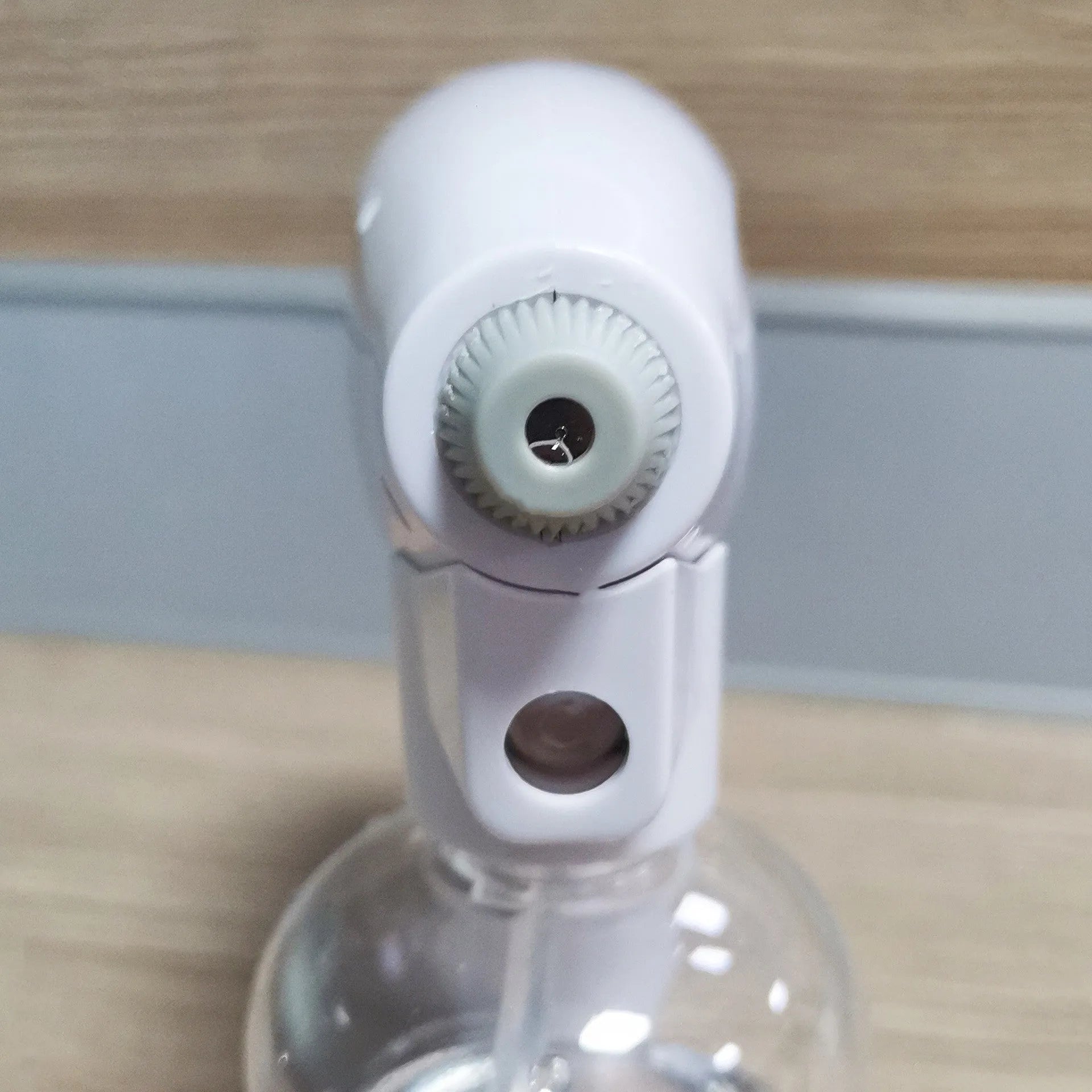 White handheld cordless electric disinfection sprayer with spray bottle.