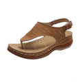 Women's black wedge heel sandals with an adjustable buckle strap on a light background.