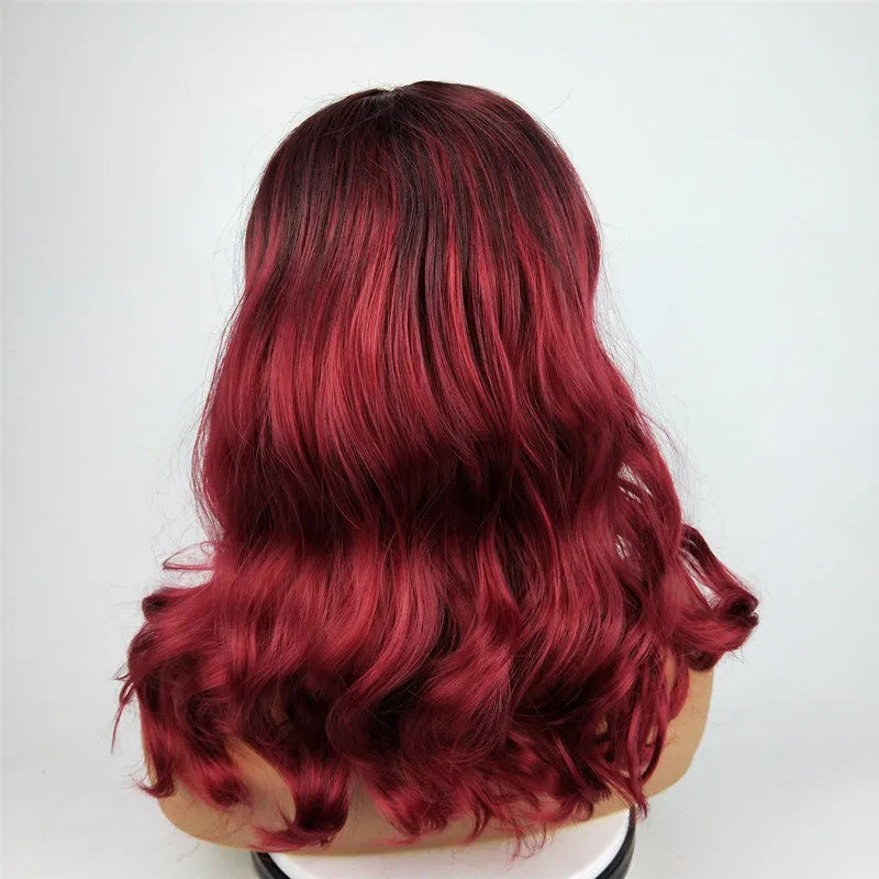 Burgundy long curly wig with gradient colour and centre bangs on a wig stand