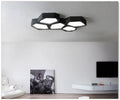 Geometric iron shade wall light with LED illumination in black or white frame