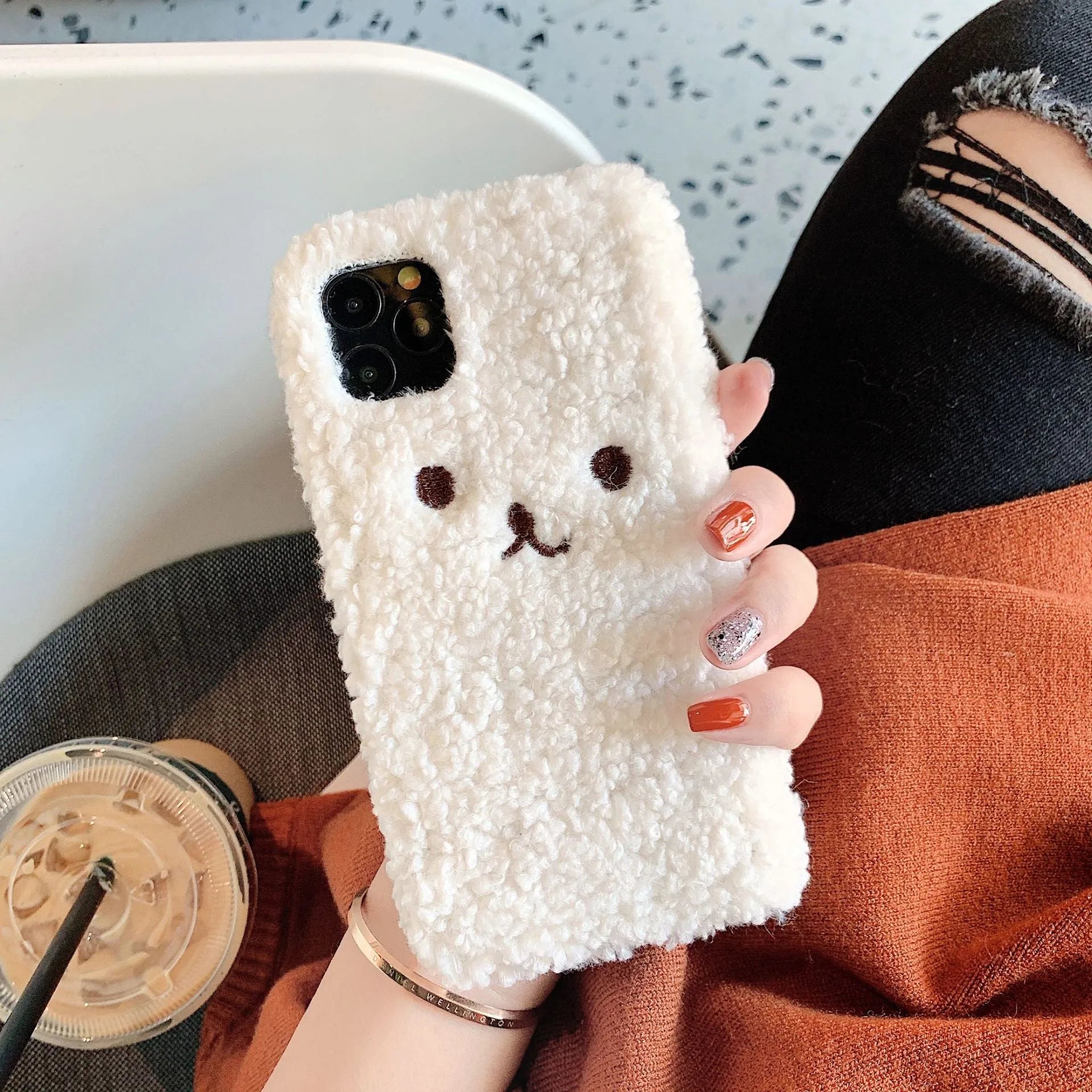Brown embroidery plush cartoon bear face design on a flexible TPU iPhone phone case.