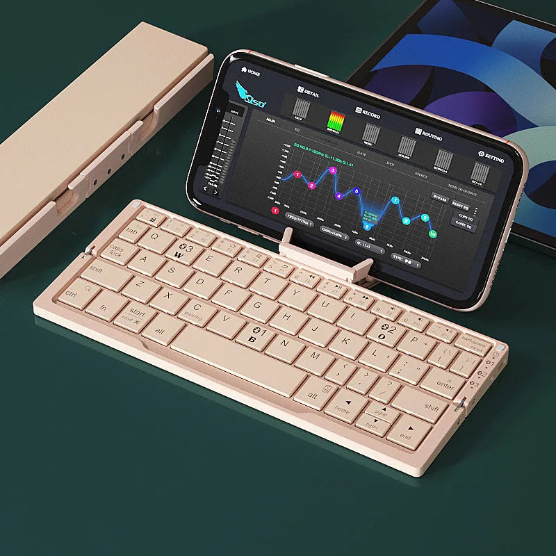 Silver white folding Bluetooth keyboard open beside smartphone showing aluminium stand