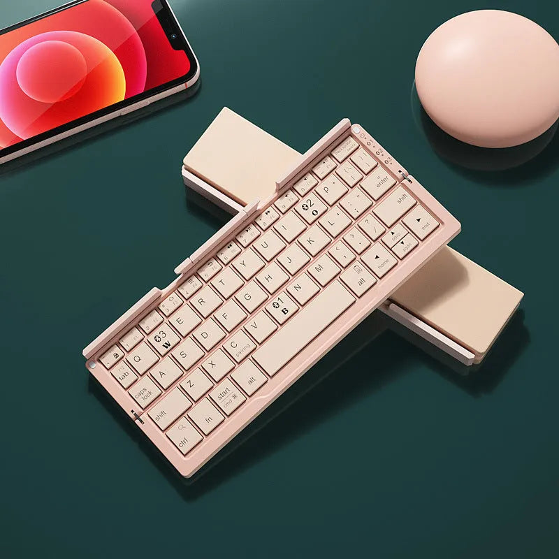 Silver white folding Bluetooth keyboard open beside smartphone showing aluminium stand