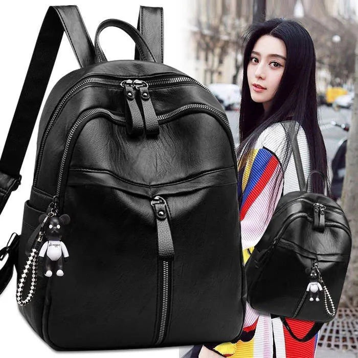 Black soft PU leather medium backpack showing double straps and luggage strap attachment