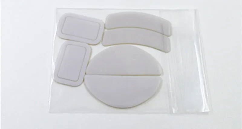 White Esports Tiger PTFE mouse skates for G PRO X Superlight on a neutral background with anti-static tweezers next to them