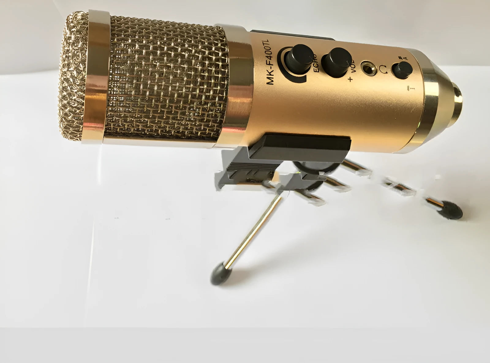 Gold condenser microphone on a stand with USB cable for mobile phone and computer use.