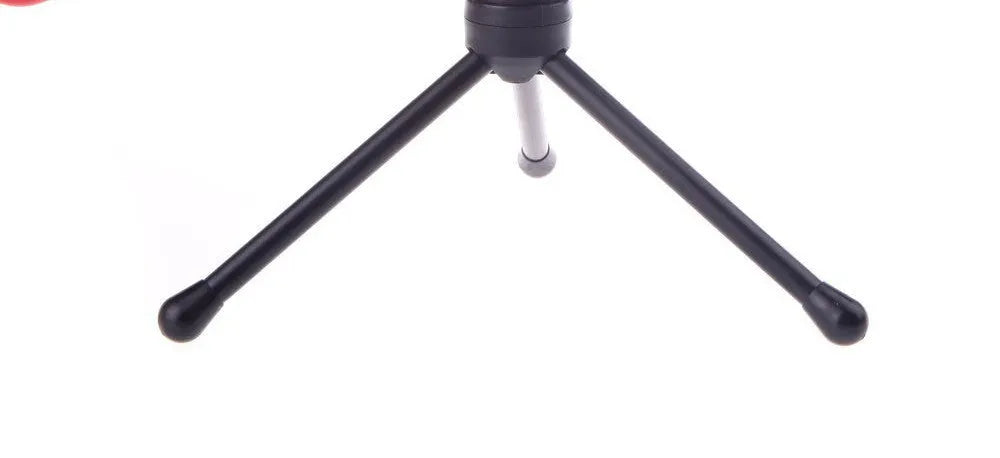 Black wired PC microphone with adjustable holder clip and mounting bracket on a desk