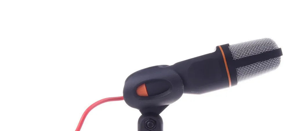 Black wired PC microphone with adjustable holder clip and mounting bracket on a desk