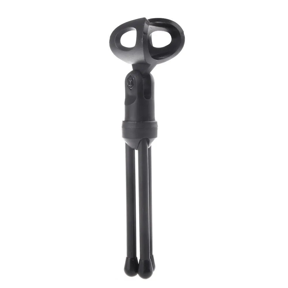 Black wired PC microphone with adjustable holder clip and mounting bracket on a desk