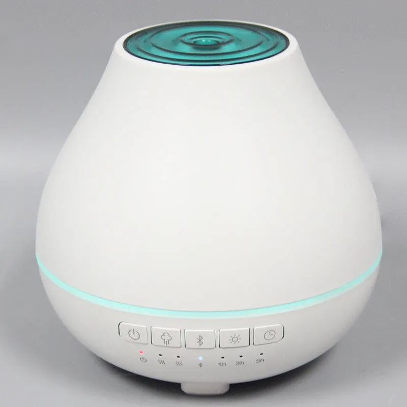 White round Bluetooth humidifier and aroma diffuser with LED night light on wooden surface