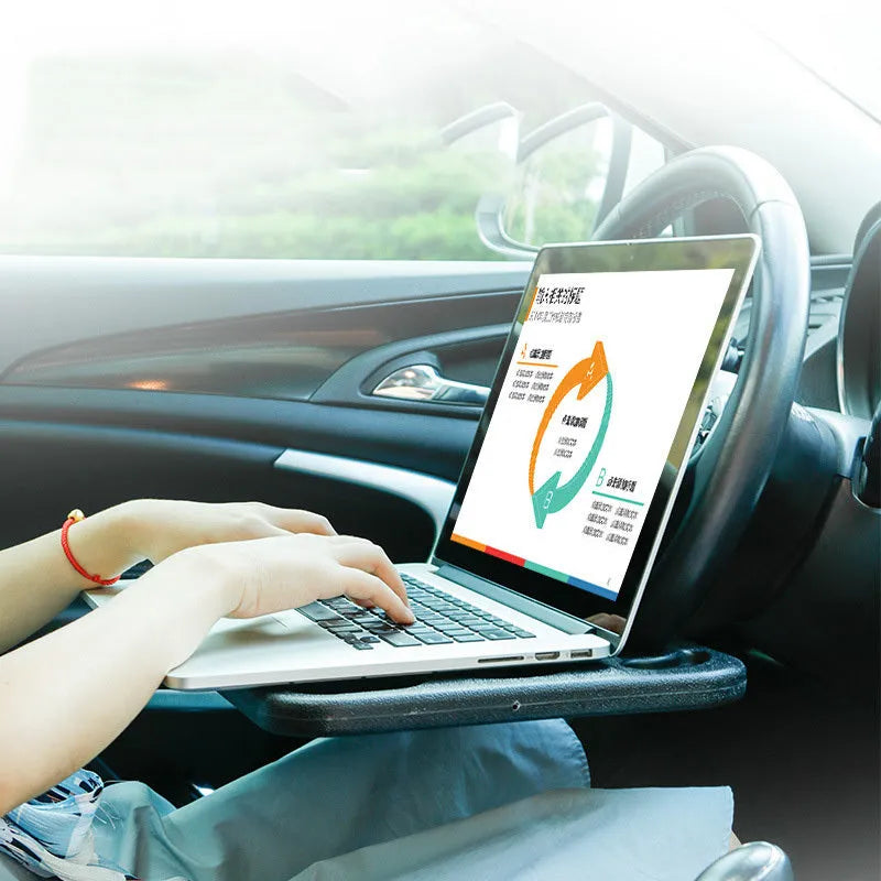 Black HDPE car steering wheel tray large size resting on a steering wheel with a laptop and cup of coffee