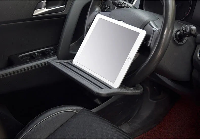 Black HDPE car steering wheel tray large size resting on a steering wheel with a laptop and cup of coffee
