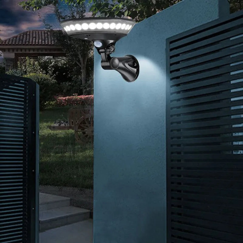 White solar-powered security light with 360-degree LED illumination and a motion sensor on a black base.