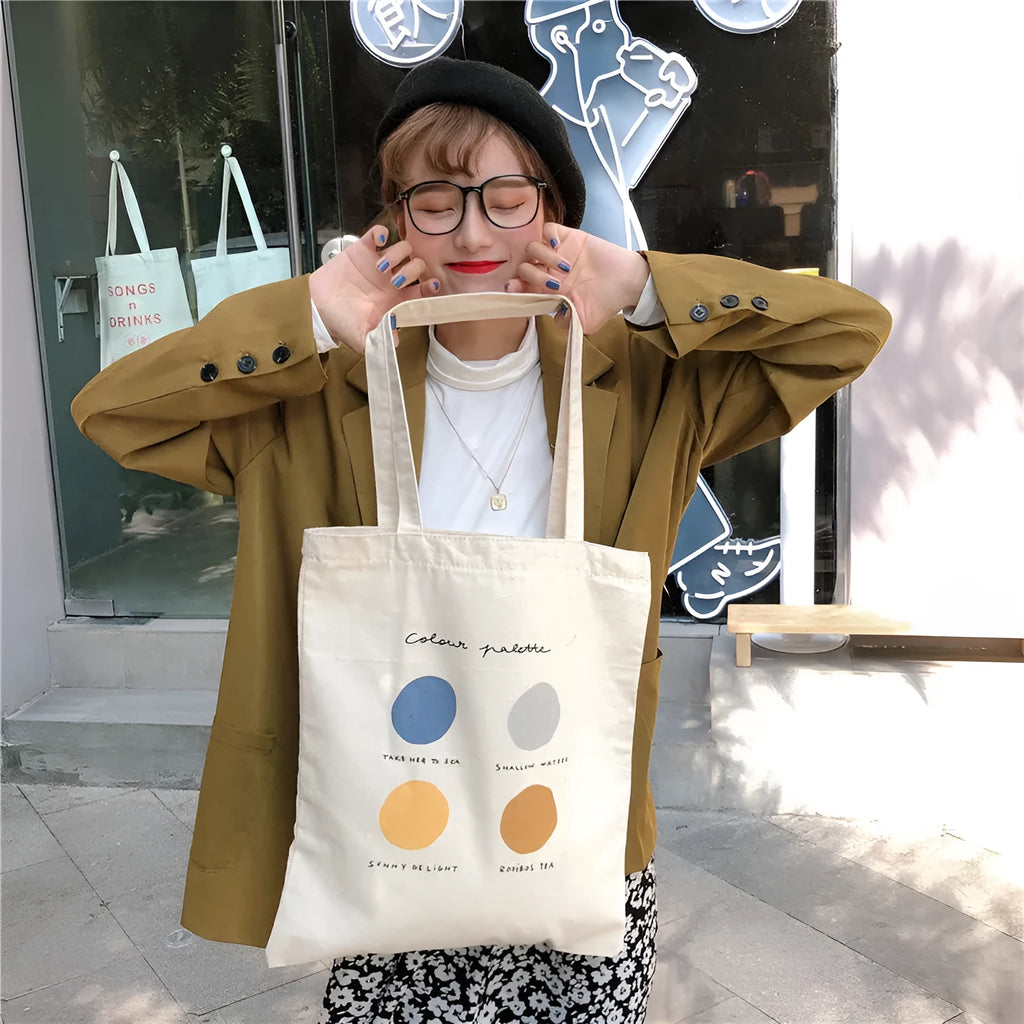 Women's canvas tote shoulder bag with geometric pattern, zip opening, and double straps in orange or light pink colour