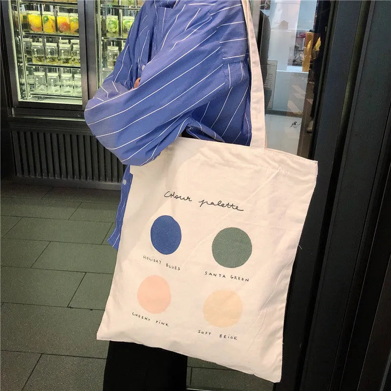Women's canvas tote shoulder bag with geometric pattern, zip opening, and double straps in orange or light pink colour