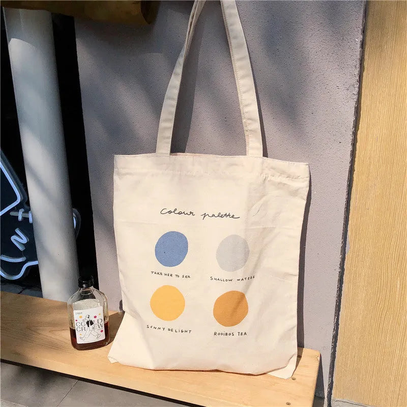 Women's canvas tote shoulder bag with geometric pattern, zip opening, and double straps in orange or light pink colour