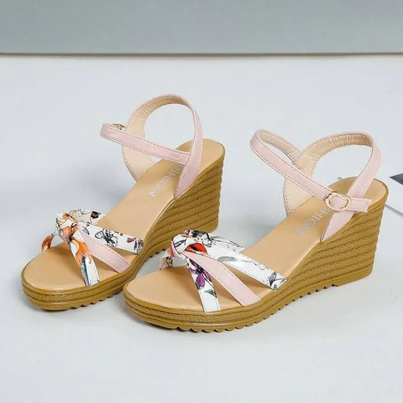 Pink and white women's wedge sandals with a thick platform sole and a single adjustable buckle strap.