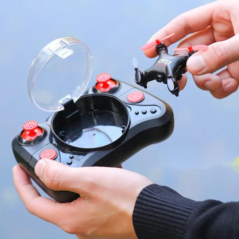 Compact bright gold fixed height remote control quadcopter aircraft with four blades and a handle-style remote.