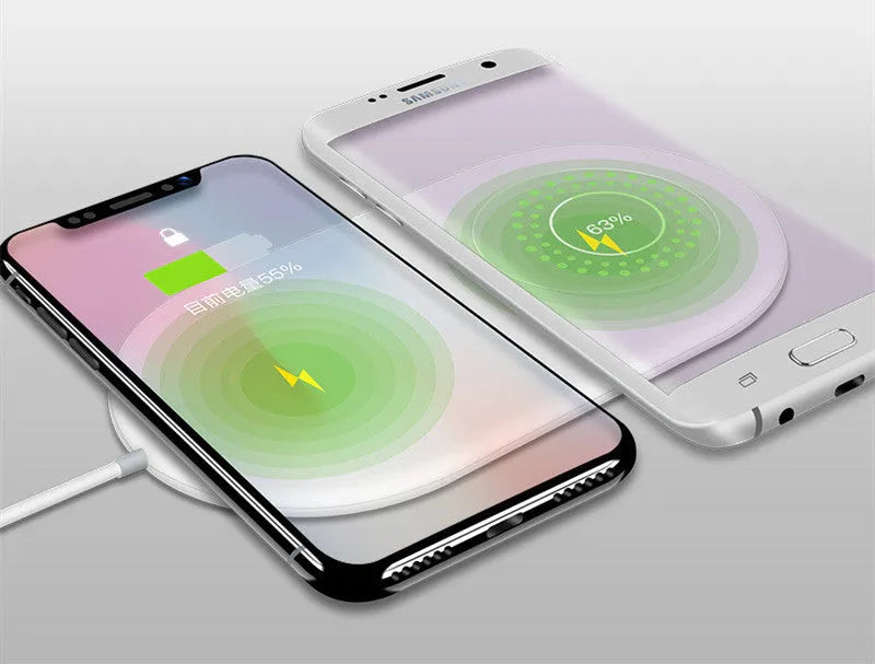 White dual wireless charging pad for two mobile phones on a desk.