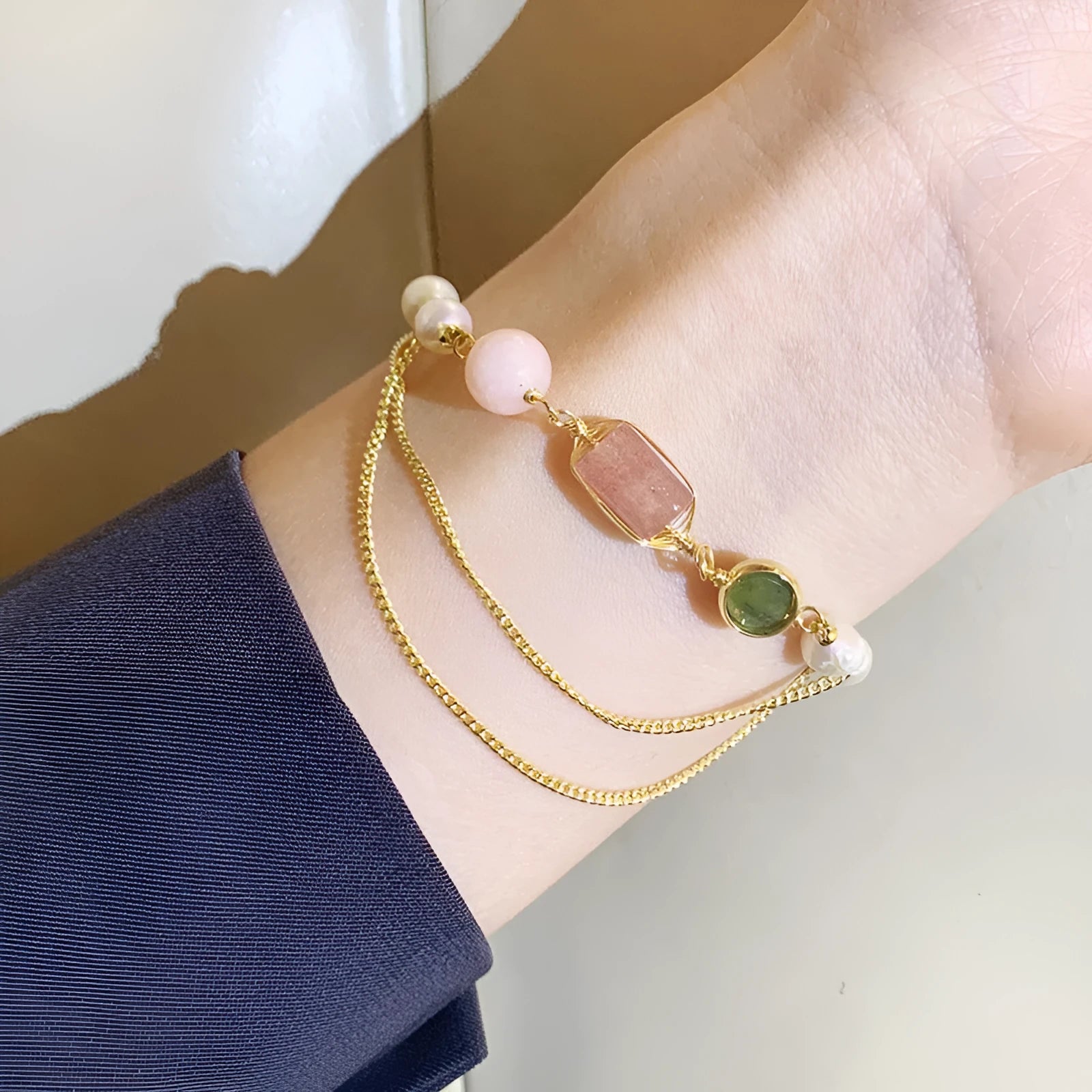 Women's geometric pink freshwater pearl bracelet with strawberry crystal charms.