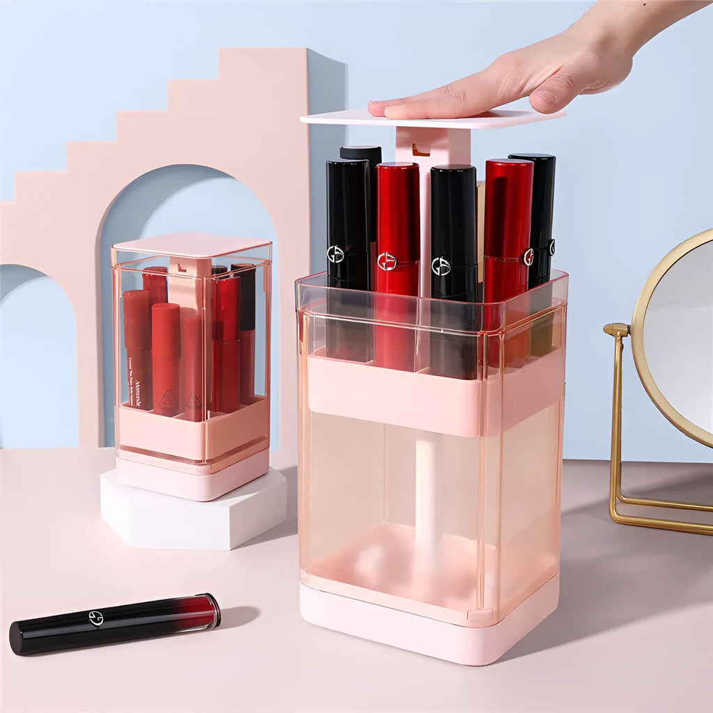 White press-lift lipstick storage box with transparent lid on a wooden desk.