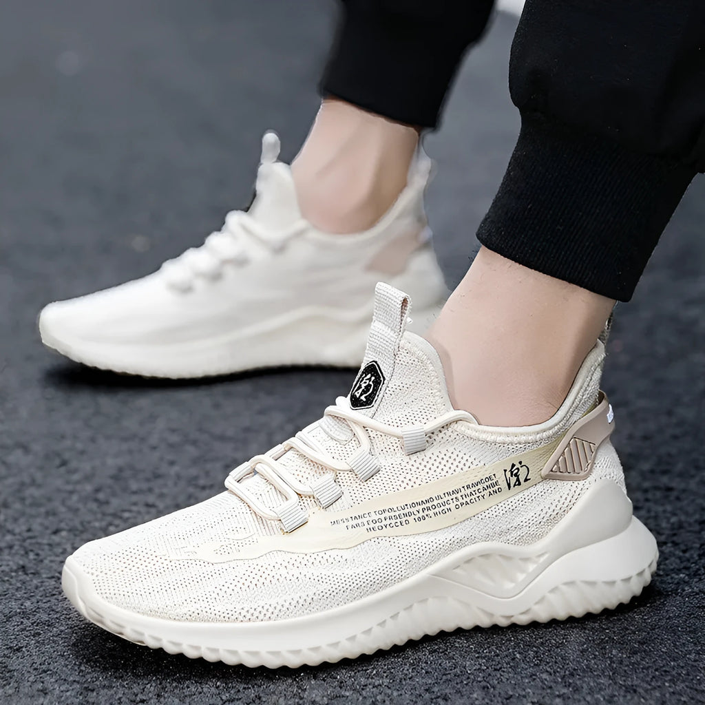 Men's white low-top casual sports shoes with mesh upper and rubber sole on a plain background.