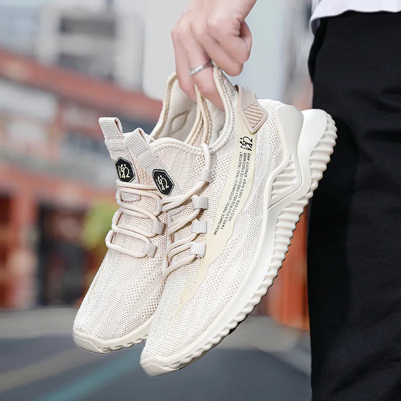 Men's white low-top casual sports shoes with mesh upper and rubber sole on a plain background.