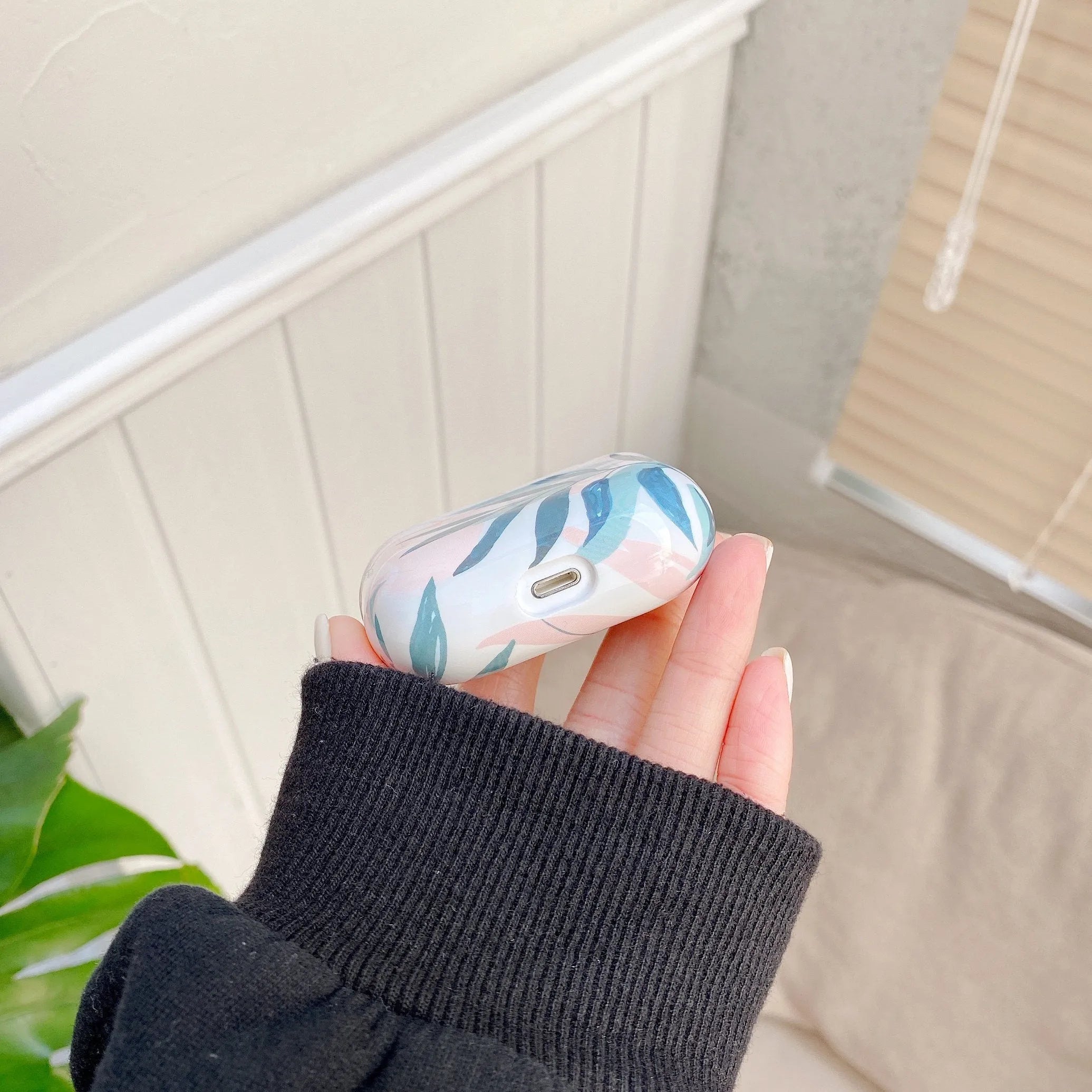 Blue TPU AirPods case cover with a detailed tropical banana leaf pattern.