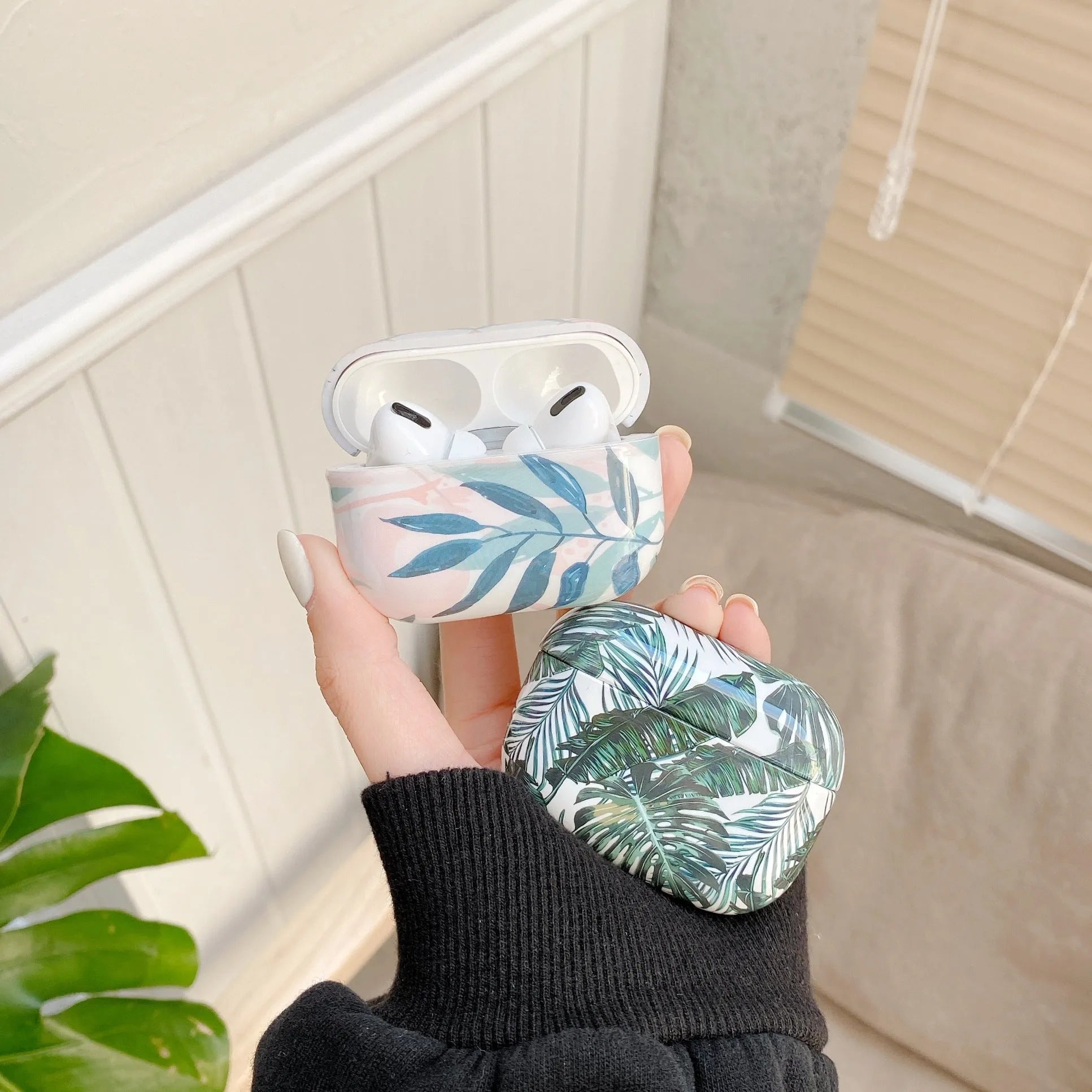 Blue TPU AirPods case cover with a detailed tropical banana leaf pattern.