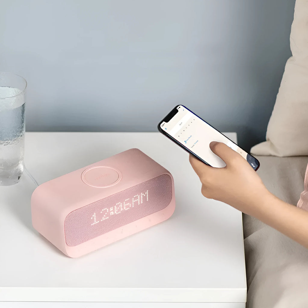 Anker Soundcore white Bluetooth speaker with wireless charging pad and LED clock display