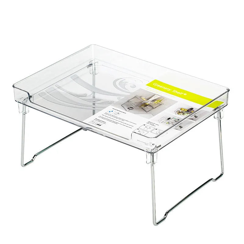 Transparent plastic kitchen supplies rack on a white countertop holding small items