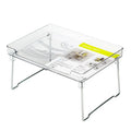 Transparent plastic kitchen supplies rack on a white countertop holding small items
