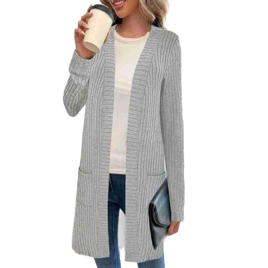 Long sleeve loose grey knitted cardigan jacket with pockets on a hanger